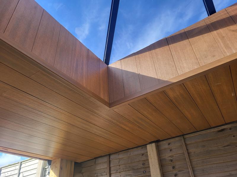 A corner of the lantern roof opening, lined in timber-effect boards