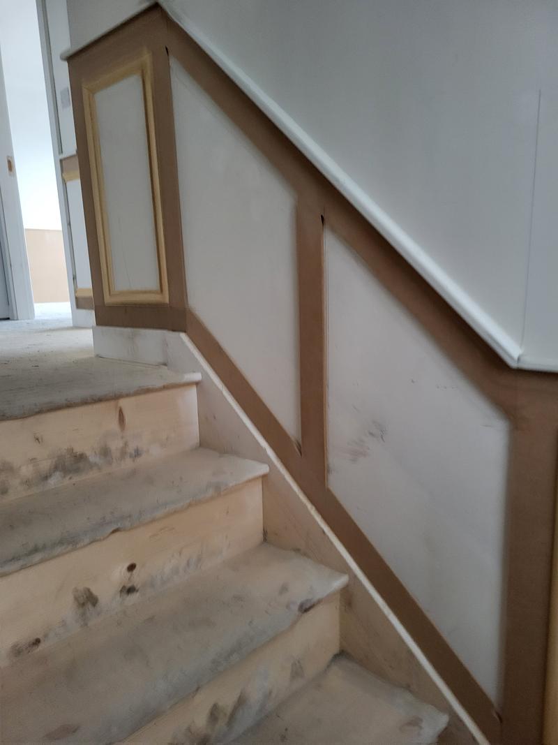 MDF frame panelling following the line of a staircase up the wall, unpainted