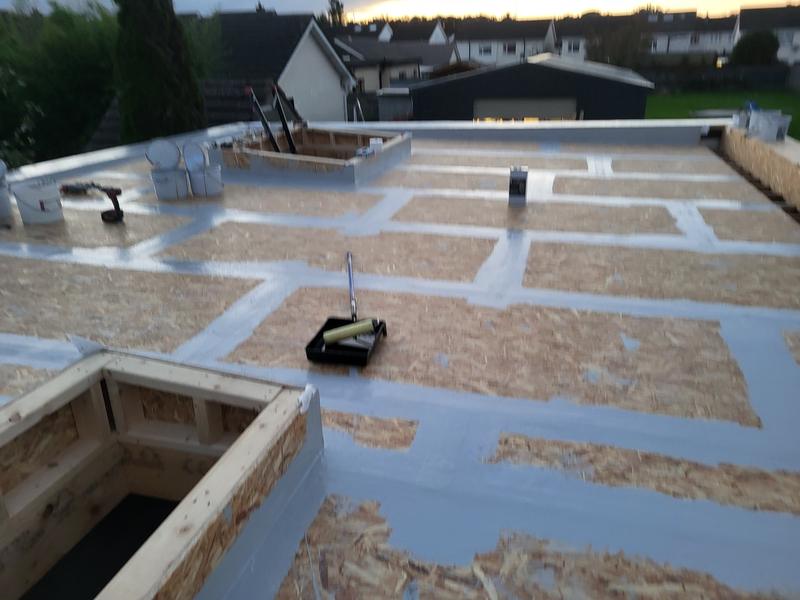 The extension roof decked in OSB boards with the joints taped, and the rooflight upstands framed
